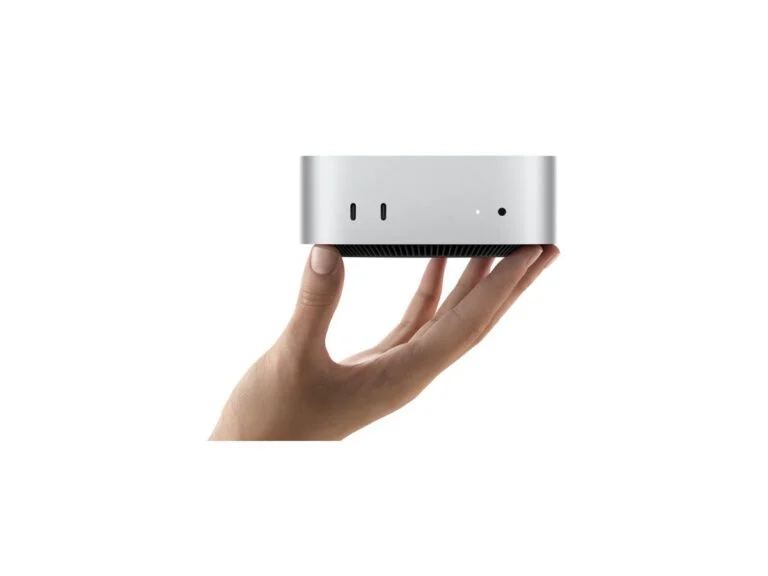 Apple Mac mini compact computer held in a hand