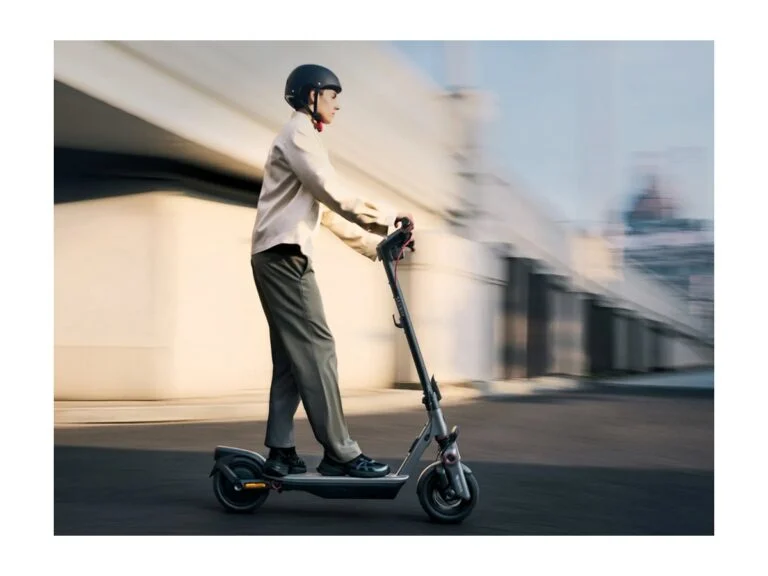 A man riding a Segway Ninebot F3 E electric scooter in the city